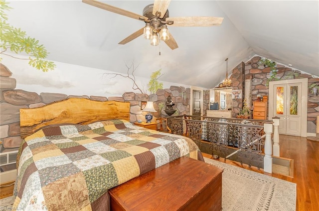 bedroom with ceiling fan, lofted ceiling, and wood-type flooring