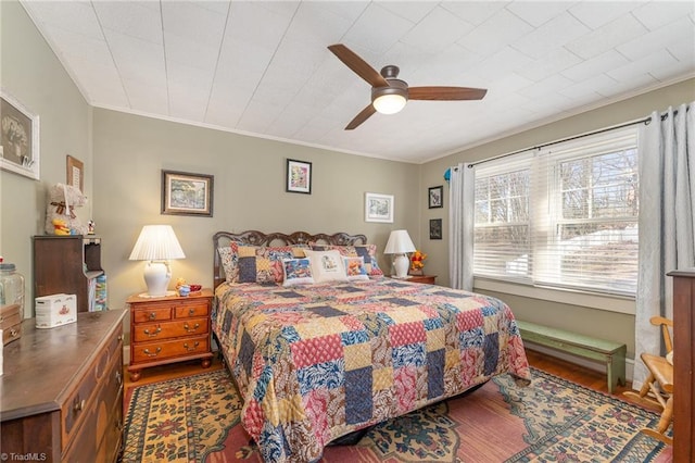 bedroom featuring ceiling fan, crown molding, and wood-type flooring