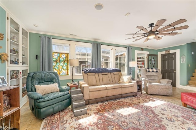 living room with ceiling fan, light tile patterned floors, and crown molding