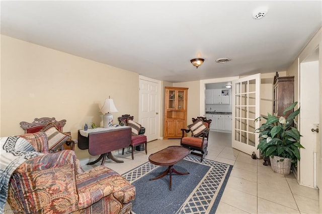 living room with french doors and light tile patterned floors