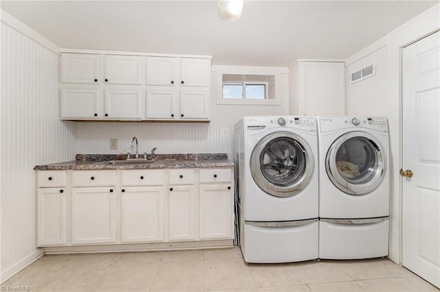 laundry area with sink, cabinets, light tile patterned flooring, and washing machine and clothes dryer