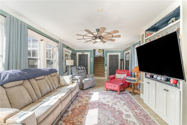 tiled living room featuring ceiling fan and crown molding