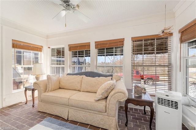 sunroom with plenty of natural light and ceiling fan