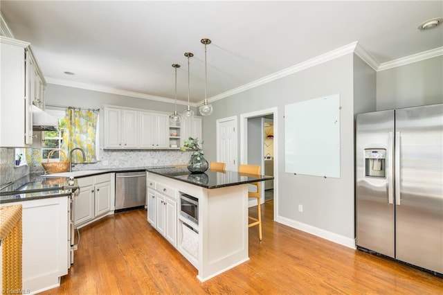 183 Scottsdale Dr, Advance, NC 27006 - kitchen featuring appliances with stainless steel finishes, a kitchen bar, open shelves, white cabinets, and crown molding