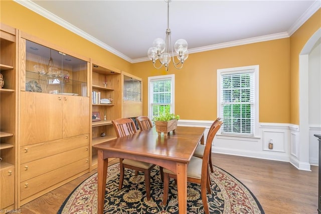 183 Scottsdale Dr, Advance, NC 27006 - dining space with wood finished floors, a chandelier, crown molding, arched walkways, and wainscoting