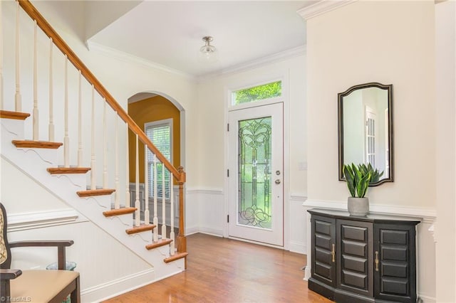 183 Scottsdale Dr, Advance, NC 27006 - foyer entrance featuring wood finished floors, arched walkways, ornamental molding, stairs, and a wainscoted wall