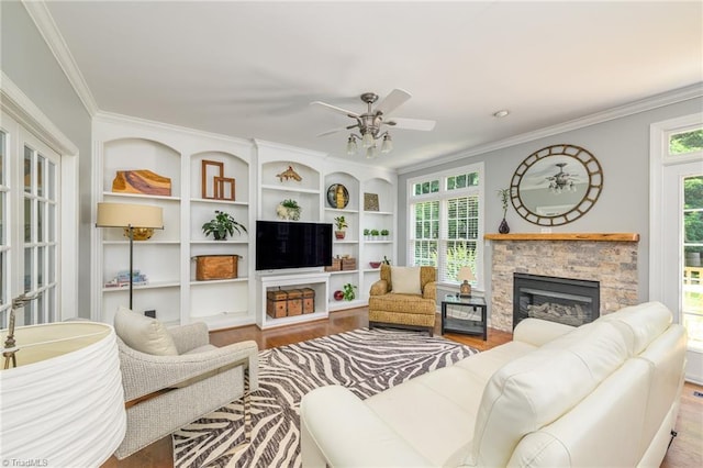 183 Scottsdale Dr, Advance, NC 27006 - living area with ornamental molding, wood finished floors, a fireplace, a ceiling fan, and built in shelves