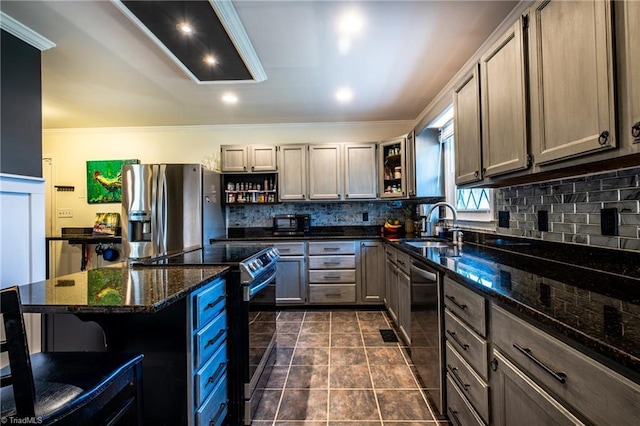 kitchen with stainless steel appliances, sink, dark stone countertops, and backsplash