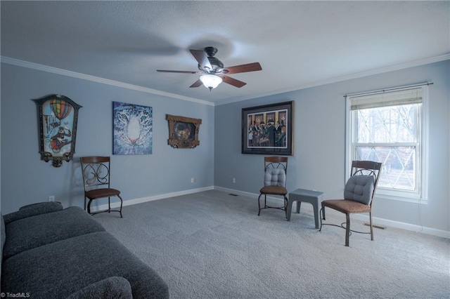 sitting room with ornamental molding, ceiling fan, and carpet flooring