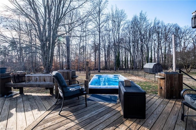 wooden deck featuring grilling area and a storage unit