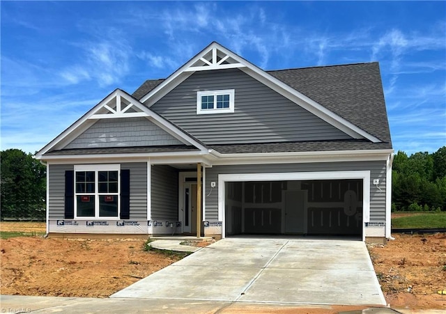 655 Ellabell Dr, Winston-Salem, NC 27127 - view of front of home featuring concrete driveway, a garage, roof with shingles, and a porch