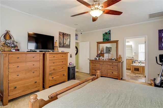 bedroom featuring baseboards, visible vents, crown molding, and ensuite bath