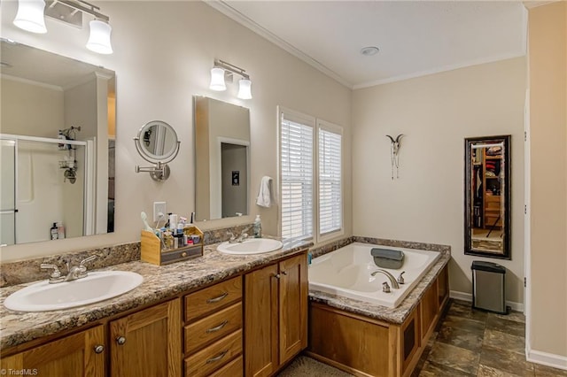 bathroom with double vanity, a stall shower, a sink, and crown molding