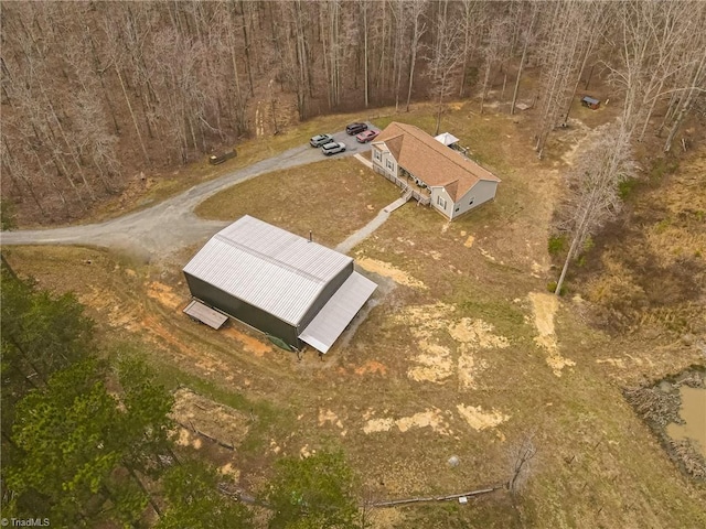 birds eye view of property featuring a wooded view