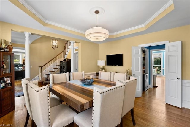 4802 Worchester Pl, Jamestown, NC 27282 - dining area featuring stairway, crown molding, wood finished floors, ornate columns, and a raised ceiling