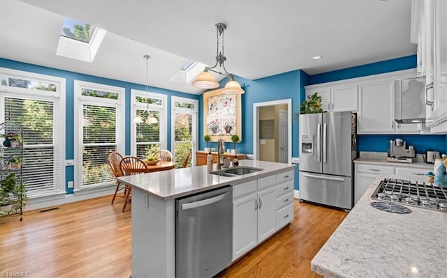 4802 Worchester Pl, Jamestown, NC 27282 - kitchen featuring appliances with stainless steel finishes, a skylight, a sink, healthy amount of natural light, and recessed lighting