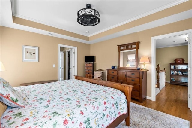 4802 Worchester Pl, Jamestown, NC 27282 - bedroom with ornamental molding, wood finished floors, a tray ceiling, and baseboards