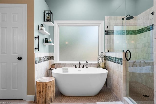 4802 Worchester Pl, Jamestown, NC 27282 - full bathroom featuring a stall shower, a soaking tub, tile walls, and wainscoting