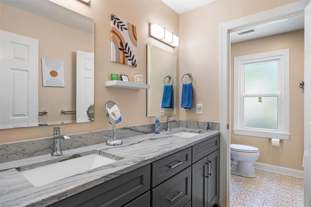 4802 Worchester Pl, Jamestown, NC 27282 - full bath with toilet, double vanity, baseboards, and tile patterned floors
