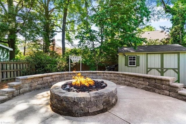 4802 Worchester Pl, Jamestown, NC 27282 - view of patio featuring an outdoor fire pit, a shed, fence, and an outbuilding