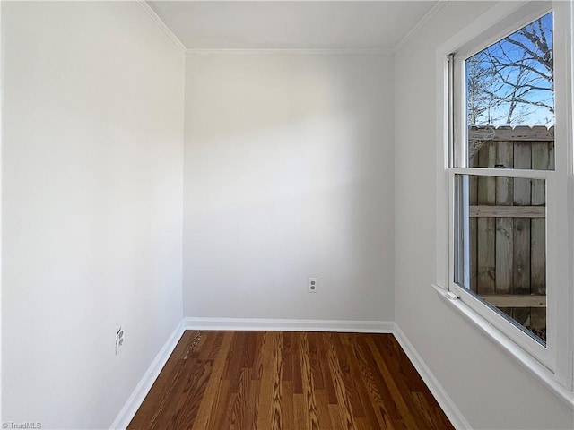 empty room with baseboards, dark wood finished floors, and ornamental molding