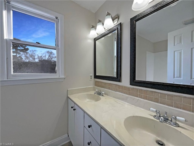 full bath with double vanity, visible vents, decorative backsplash, and a sink