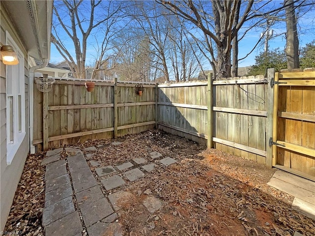 view of yard with a gate and a fenced backyard