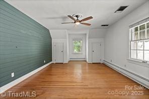 720 Ferndale Blvd, High Point, NC 27262 - unfurnished living room with baseboards, a baseboard radiator, a ceiling fan, and wood finished floors