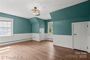 720 Ferndale Blvd, High Point, NC 27262 - additional living space with a baseboard heating unit, lofted ceiling, and wood finished floors