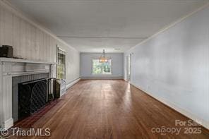 720 Ferndale Blvd, High Point, NC 27262 - unfurnished living room with a fireplace, wood finished floors, crown molding, and baseboards