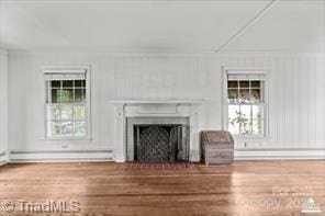 720 Ferndale Blvd, High Point, NC 27262 - unfurnished living room featuring a fireplace, wood finished floors, and a baseboard radiator