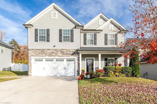 view of front of property with a front yard, a garage, and cooling unit