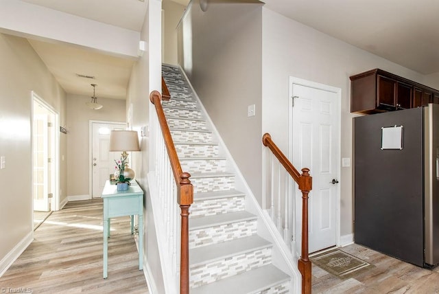 stairway featuring wood-type flooring