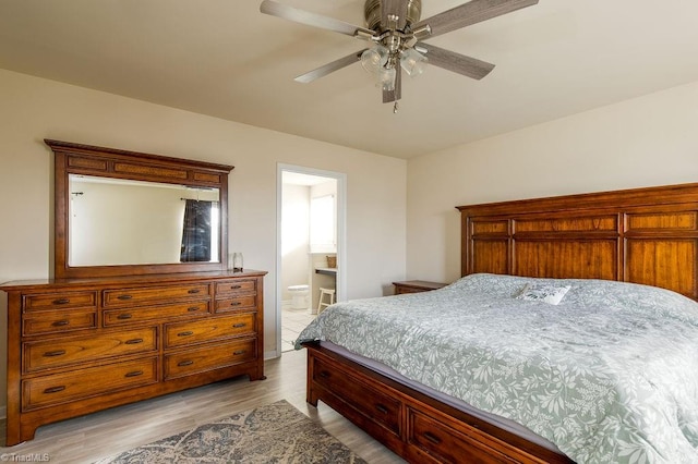 bedroom with light hardwood / wood-style floors, ensuite bath, and ceiling fan