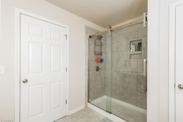 bathroom with tile patterned floors and a shower with door