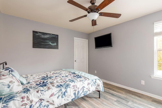 bedroom with ceiling fan and light wood-type flooring