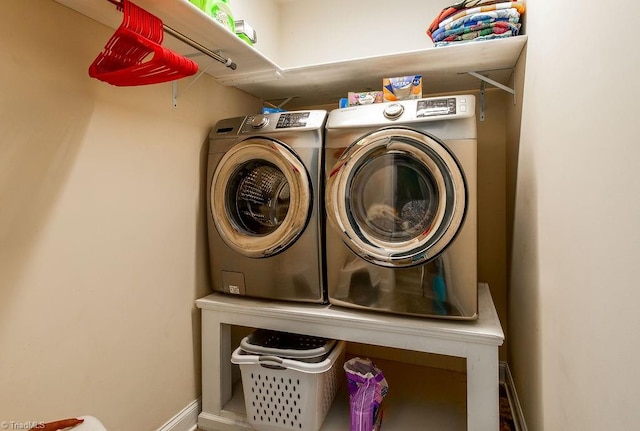 clothes washing area featuring washer and dryer