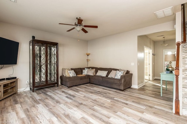 living room featuring light hardwood / wood-style flooring and ceiling fan