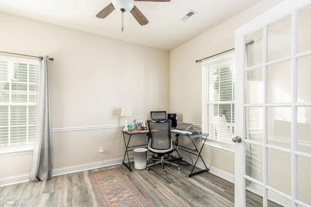 office area with hardwood / wood-style flooring, plenty of natural light, and ceiling fan