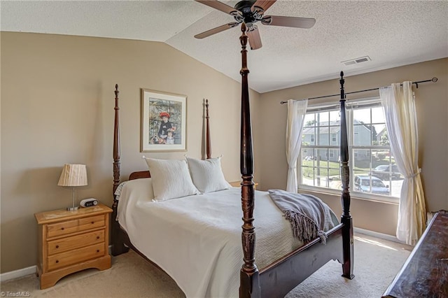 bedroom with visible vents, baseboards, light colored carpet, and vaulted ceiling