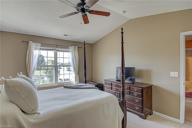 bedroom with visible vents, baseboards, light colored carpet, lofted ceiling, and a textured ceiling