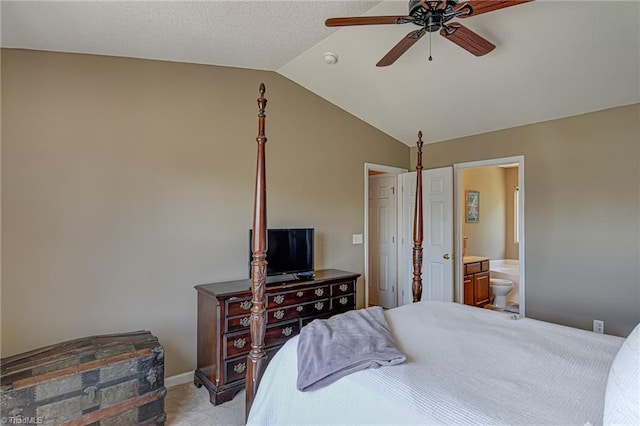 bedroom with a ceiling fan, baseboards, ensuite bath, lofted ceiling, and light colored carpet