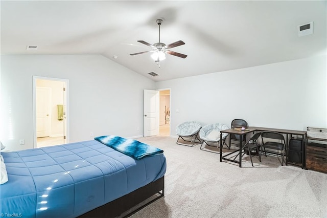 bedroom with carpet floors, vaulted ceiling, ceiling fan, and connected bathroom