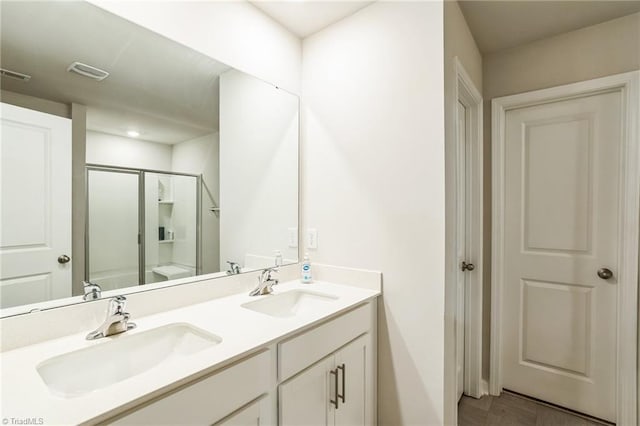 bathroom featuring vanity, wood-type flooring, and walk in shower