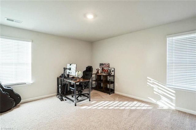 office area featuring light colored carpet and plenty of natural light