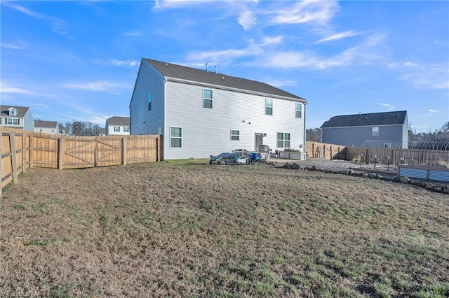 rear view of house featuring a lawn