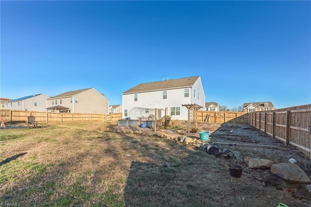 rear view of property featuring a yard