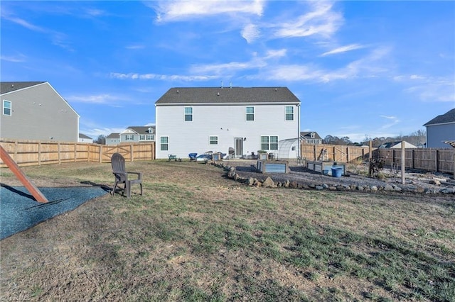 back of house featuring a yard