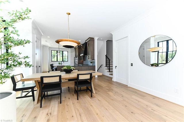 dining area with baseboards, stairs, light wood-style flooring, and recessed lighting