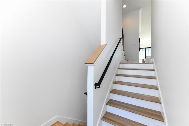 stairs with baseboards and recessed lighting